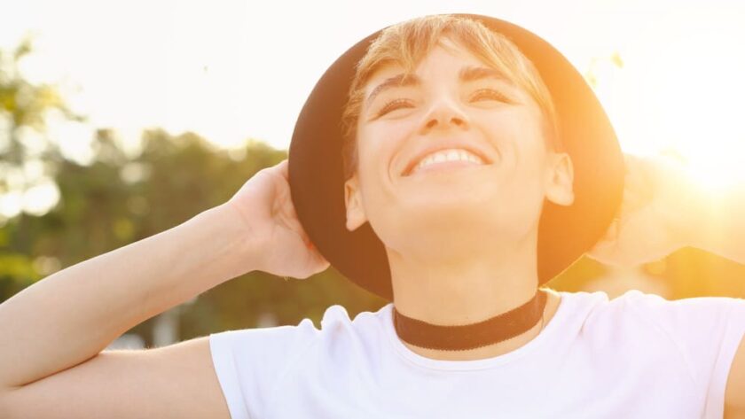 Persona sonriendo bajo el sol